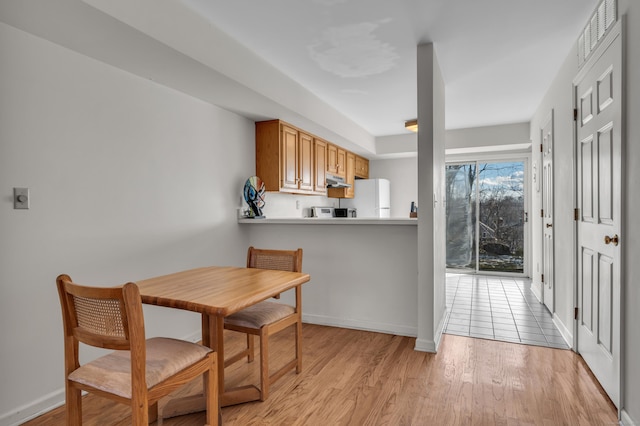 dining room with light wood-type flooring