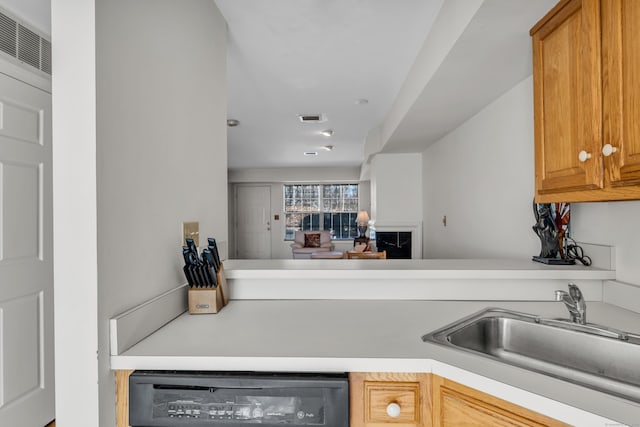 kitchen with dishwasher, sink, and kitchen peninsula