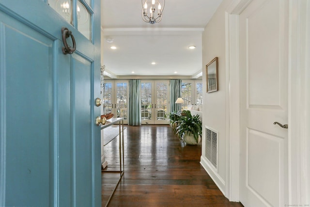 entryway with french doors, dark hardwood / wood-style flooring, and an inviting chandelier