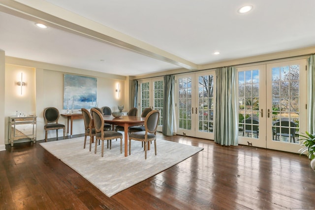 dining space with beamed ceiling, a healthy amount of sunlight, dark hardwood / wood-style flooring, and french doors