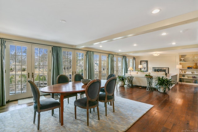 dining room featuring wood-type flooring, french doors, beamed ceiling, and plenty of natural light