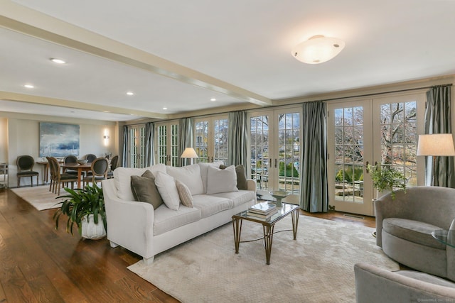 living room with french doors, hardwood / wood-style floors, and beamed ceiling