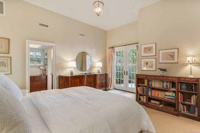 bedroom featuring french doors, light colored carpet, and access to exterior