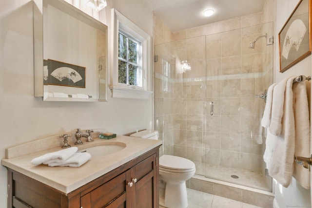 bathroom featuring vanity, tile patterned flooring, a shower with shower door, and toilet