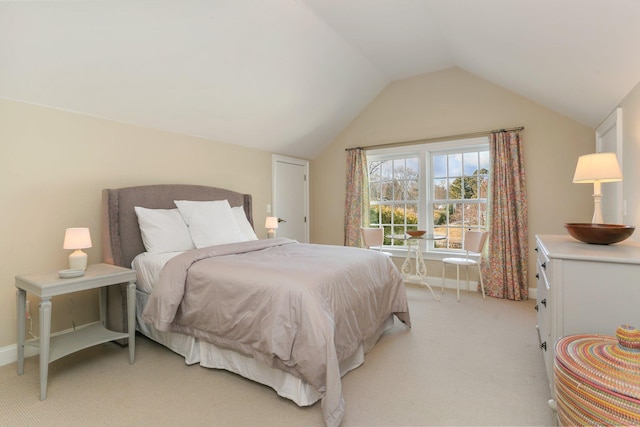 bedroom featuring vaulted ceiling and light colored carpet