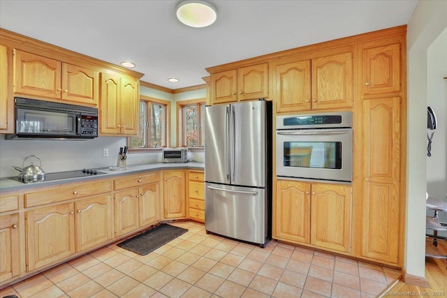 kitchen featuring a toaster, crown molding, light countertops, light tile patterned flooring, and black appliances