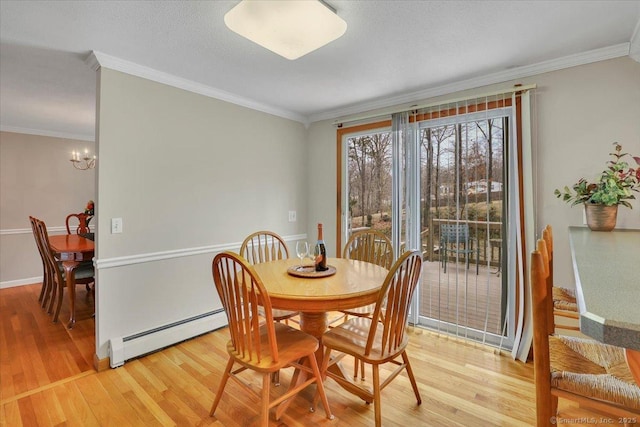 dining space featuring light wood-style floors, a baseboard radiator, ornamental molding, and an inviting chandelier