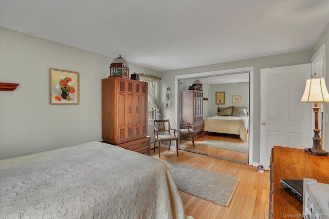 bedroom featuring a closet and light wood-style flooring