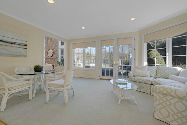 living room featuring ornamental molding, light carpet, and french doors