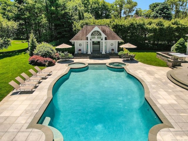 view of pool featuring a yard, an outdoor structure, a patio, and an in ground hot tub