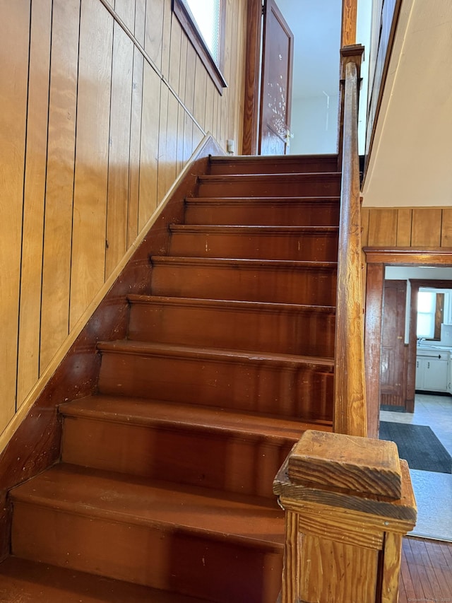 stairs featuring wooden walls