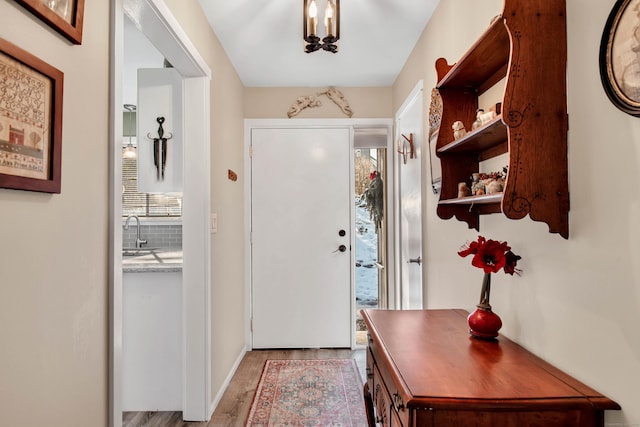 entryway featuring sink and light wood-type flooring