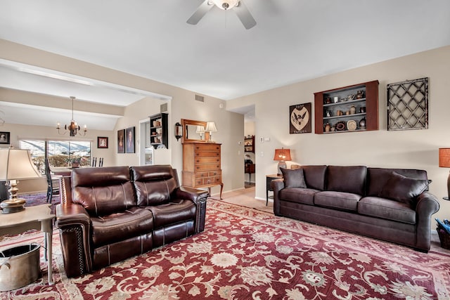 living room featuring beamed ceiling, ceiling fan with notable chandelier, and light carpet