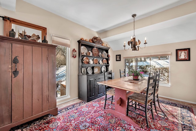 dining area with lofted ceiling, a wealth of natural light, and an inviting chandelier