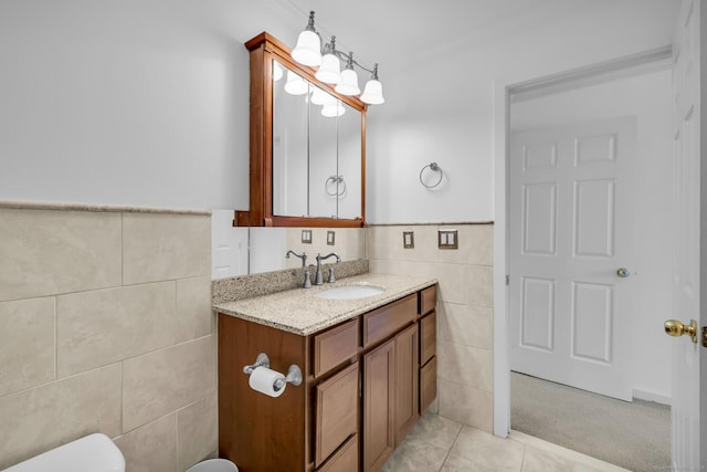 bathroom with tile walls, vanity, tile patterned flooring, and toilet