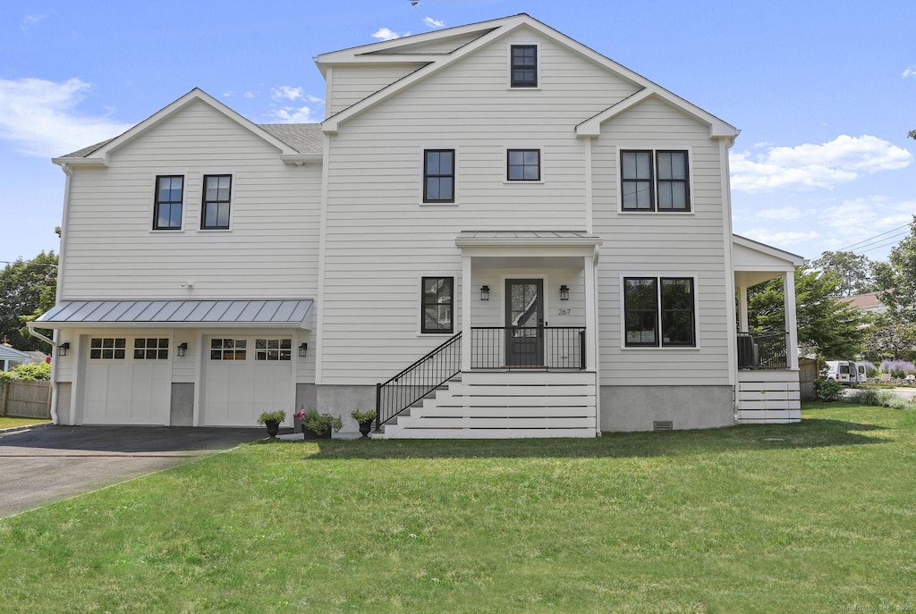 view of front of home featuring a garage and a front lawn