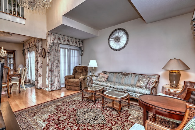 living room featuring a chandelier and wood-type flooring