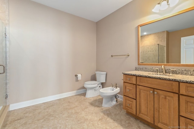 bathroom with a bidet, toilet, vanity, and a shower with shower door