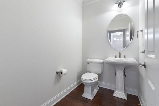 bathroom with hardwood / wood-style floors, ornamental molding, and toilet