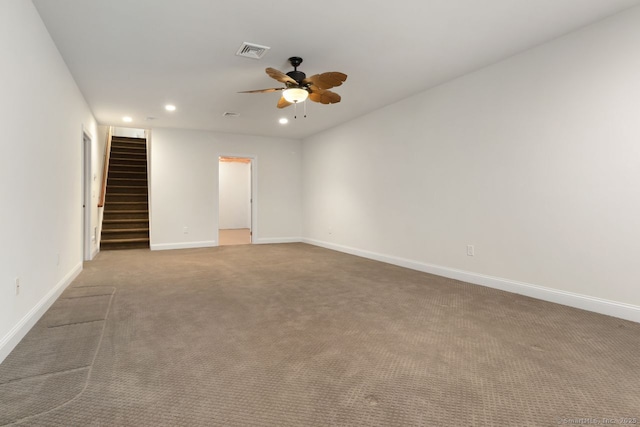 carpeted spare room featuring ceiling fan