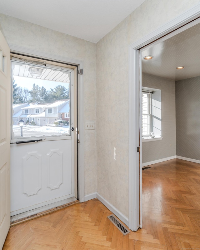 doorway with light parquet floors