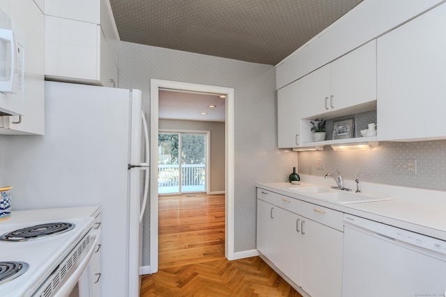 kitchen featuring light parquet floors, sink, white cabinets, and white appliances