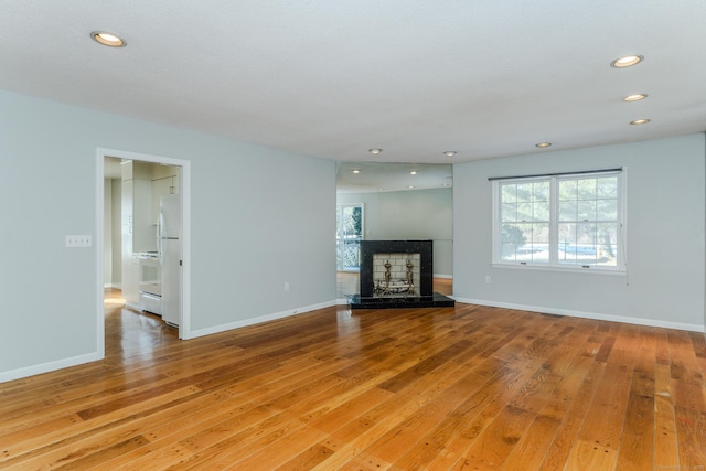 unfurnished living room with light hardwood / wood-style flooring