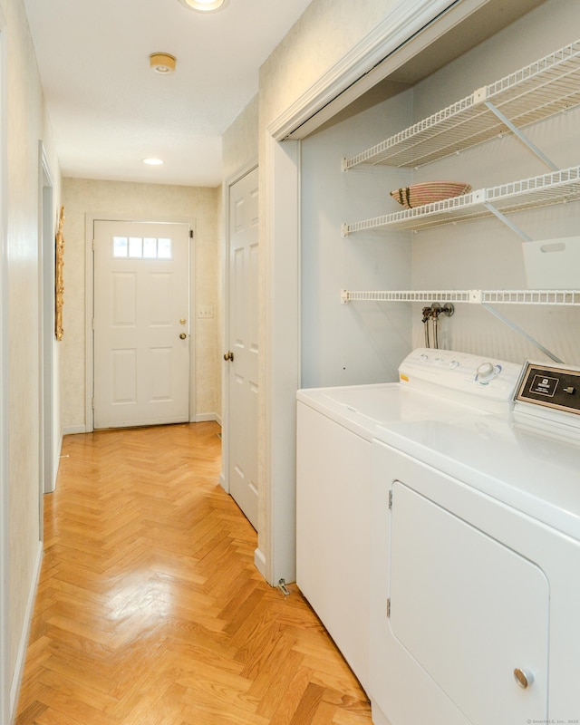 laundry area featuring light parquet flooring and independent washer and dryer