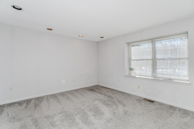 unfurnished room featuring light colored carpet