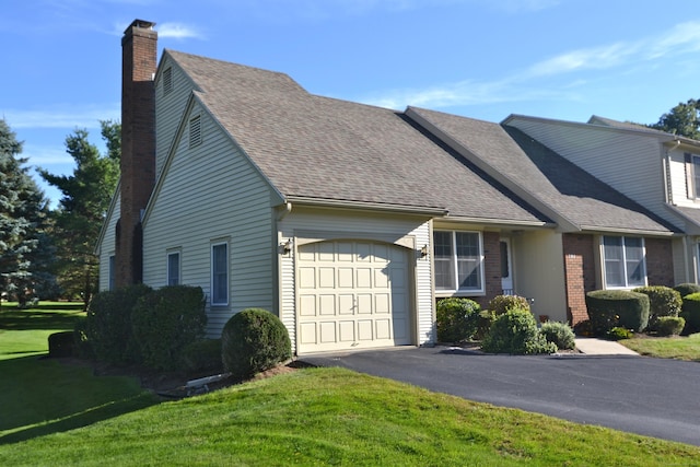 view of front facade featuring a garage and a front lawn