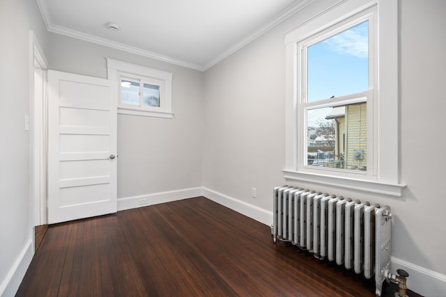 empty room with dark wood-type flooring, radiator heating unit, and crown molding