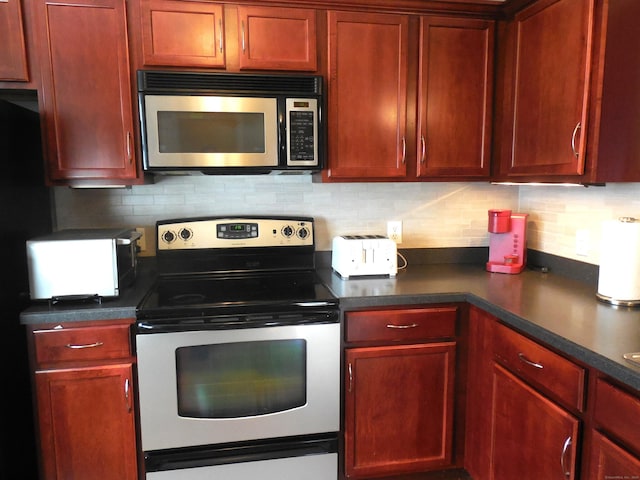 kitchen featuring appliances with stainless steel finishes and decorative backsplash