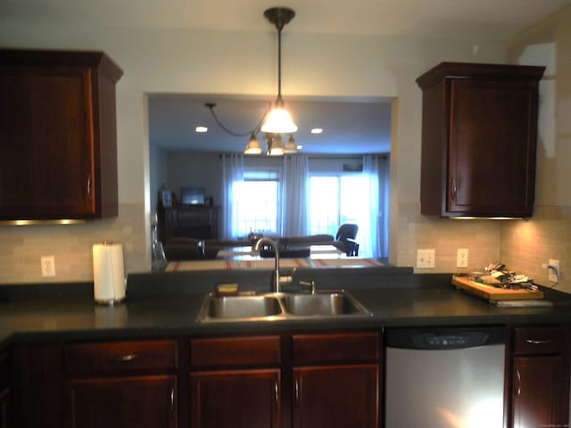 kitchen featuring tasteful backsplash, dishwasher, sink, hanging light fixtures, and kitchen peninsula