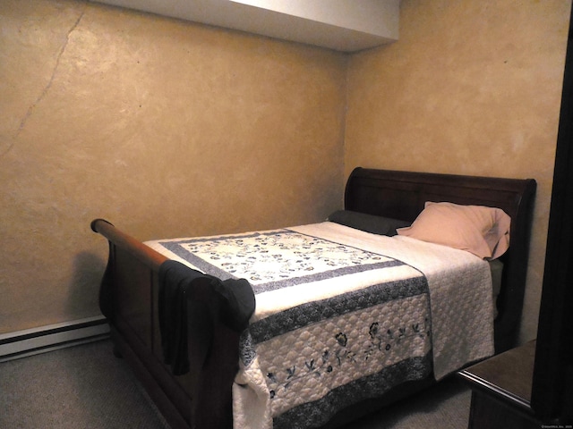 carpeted bedroom featuring a baseboard heating unit