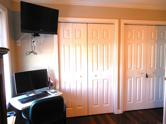 home office with dark hardwood / wood-style flooring and ornamental molding