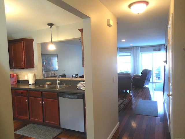 kitchen with pendant lighting, dishwasher, sink, backsplash, and dark wood-type flooring