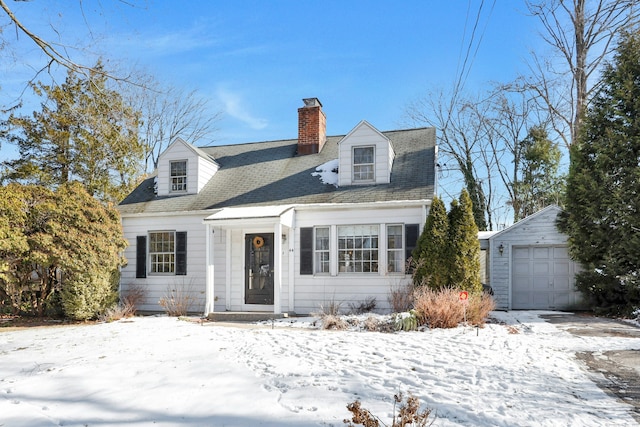 new england style home with an outbuilding and a garage