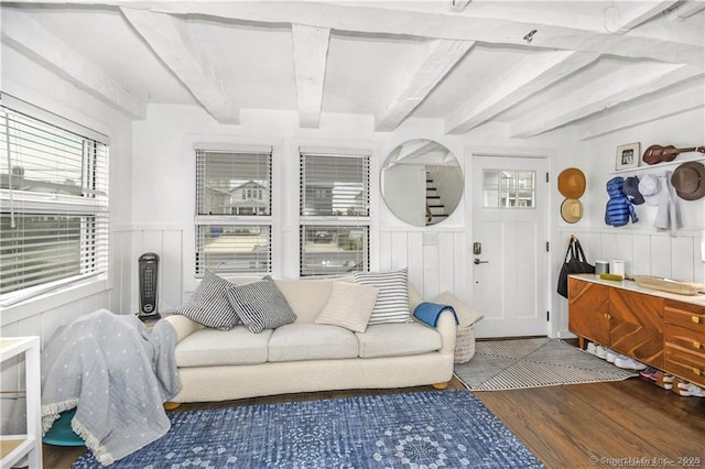 living room featuring dark hardwood / wood-style flooring and beam ceiling