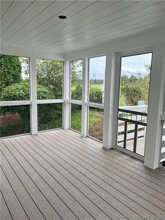 unfurnished sunroom featuring wood ceiling