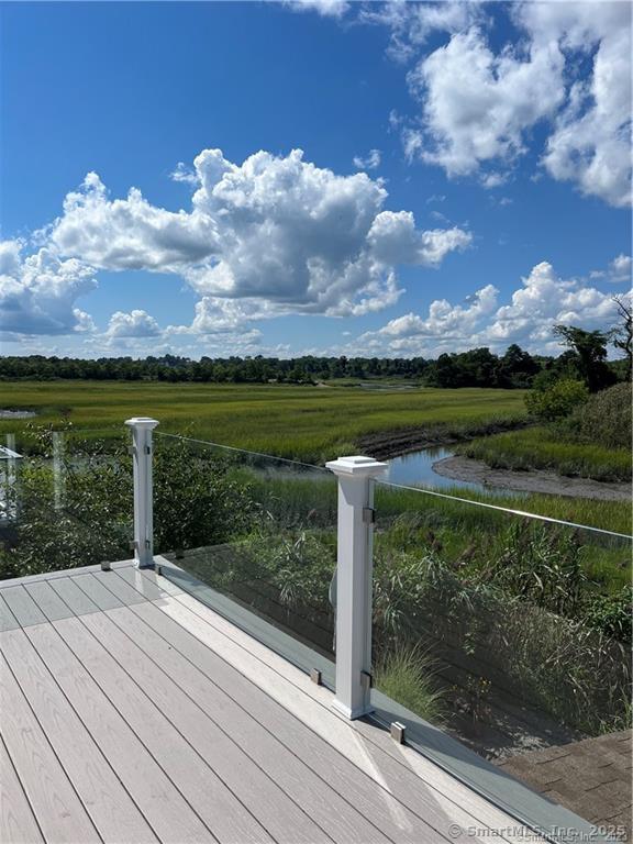 deck with a rural view and a water view