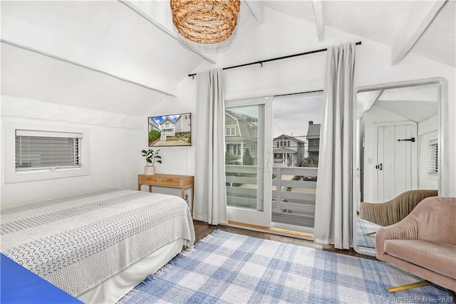 bedroom featuring lofted ceiling with beams, hardwood / wood-style floors, and access to exterior