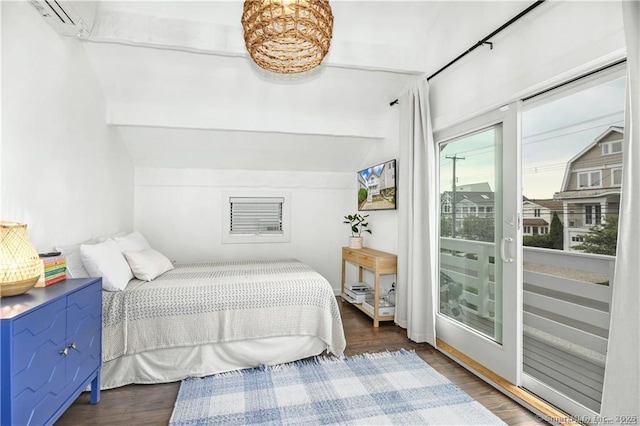 bedroom featuring a wall mounted air conditioner, dark hardwood / wood-style flooring, vaulted ceiling, and access to outside