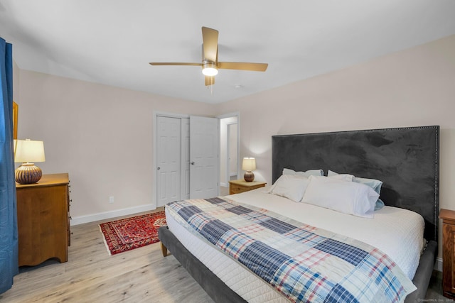 bedroom with light hardwood / wood-style flooring, a closet, and ceiling fan