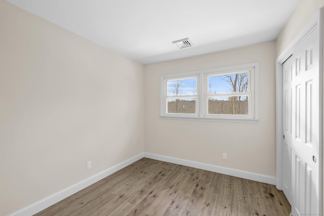 unfurnished bedroom featuring a closet and light wood-type flooring