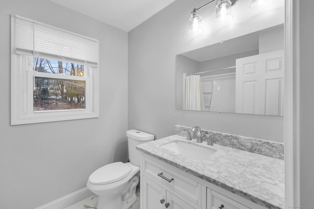 bathroom with vanity, toilet, and curtained shower