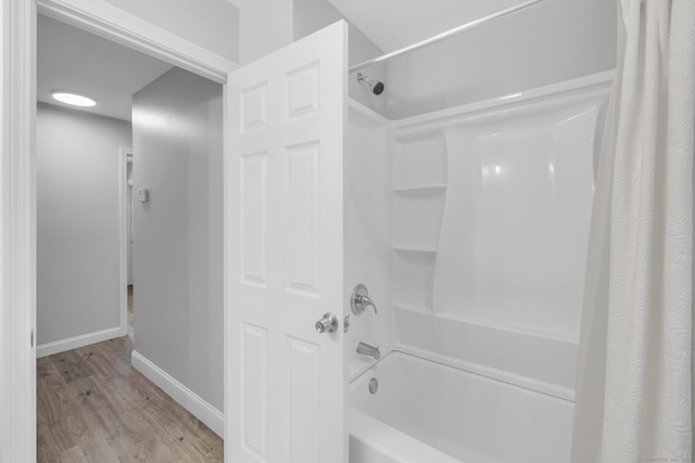 bathroom featuring hardwood / wood-style flooring and shower / bath combo with shower curtain