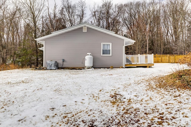 view of snow covered exterior with a deck