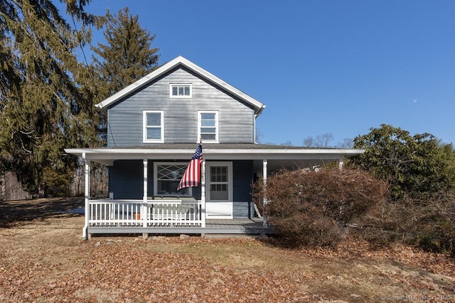 farmhouse inspired home featuring covered porch