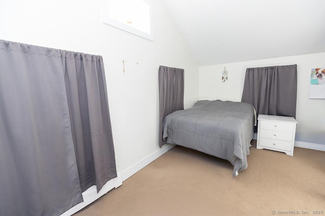 bedroom with vaulted ceiling and carpet