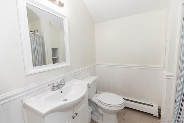 bathroom with tile patterned flooring, vanity, toilet, and baseboard heating